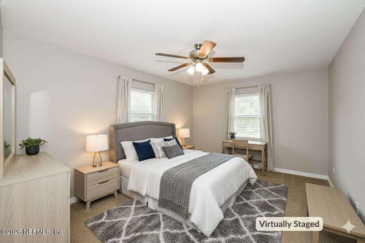 1480 Stimson Street Jacksonville, FL 32205 - Photo 13 of 21 a bedroom with a bed and a chandelier