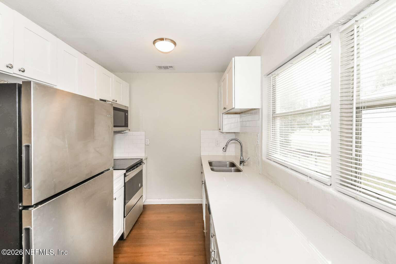 1480 Stimson Street Jacksonville, FL 32205 - Photo 16 of 21 a kitchen with stainless steel appliances a refrigerator and a window