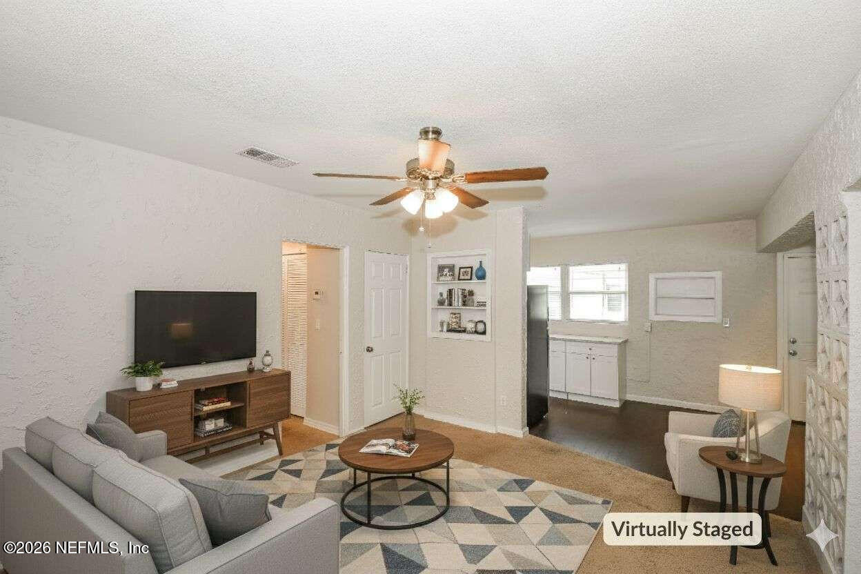 1480 Stimson Street Jacksonville, FL 32205 - Photo 2 of 21 a living room with furniture a flat screen tv and a window