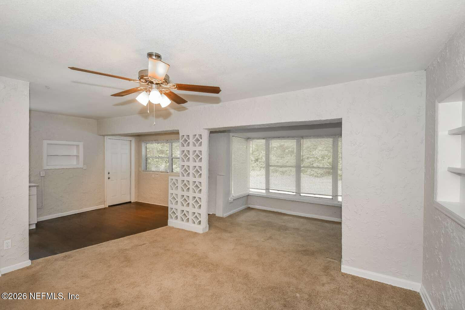 1480 Stimson Street Jacksonville, FL 32205 - Photo 7 of 21 an empty room with windows and chandelier fan