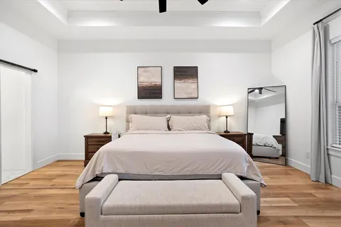 a bedroom with a bed and a night stand