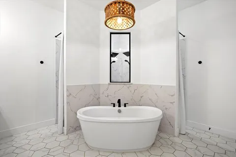 a bathroom with a bathtub and shower