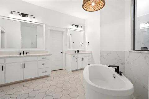 a spacious bathroom with double sink and a mirror