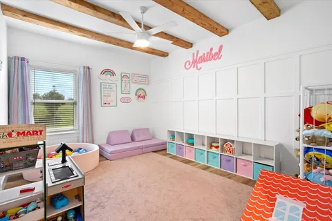 a bedroom with furniture and a book shelf
