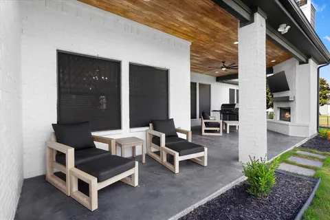 a building outdoor space with patio furniture and potted plants