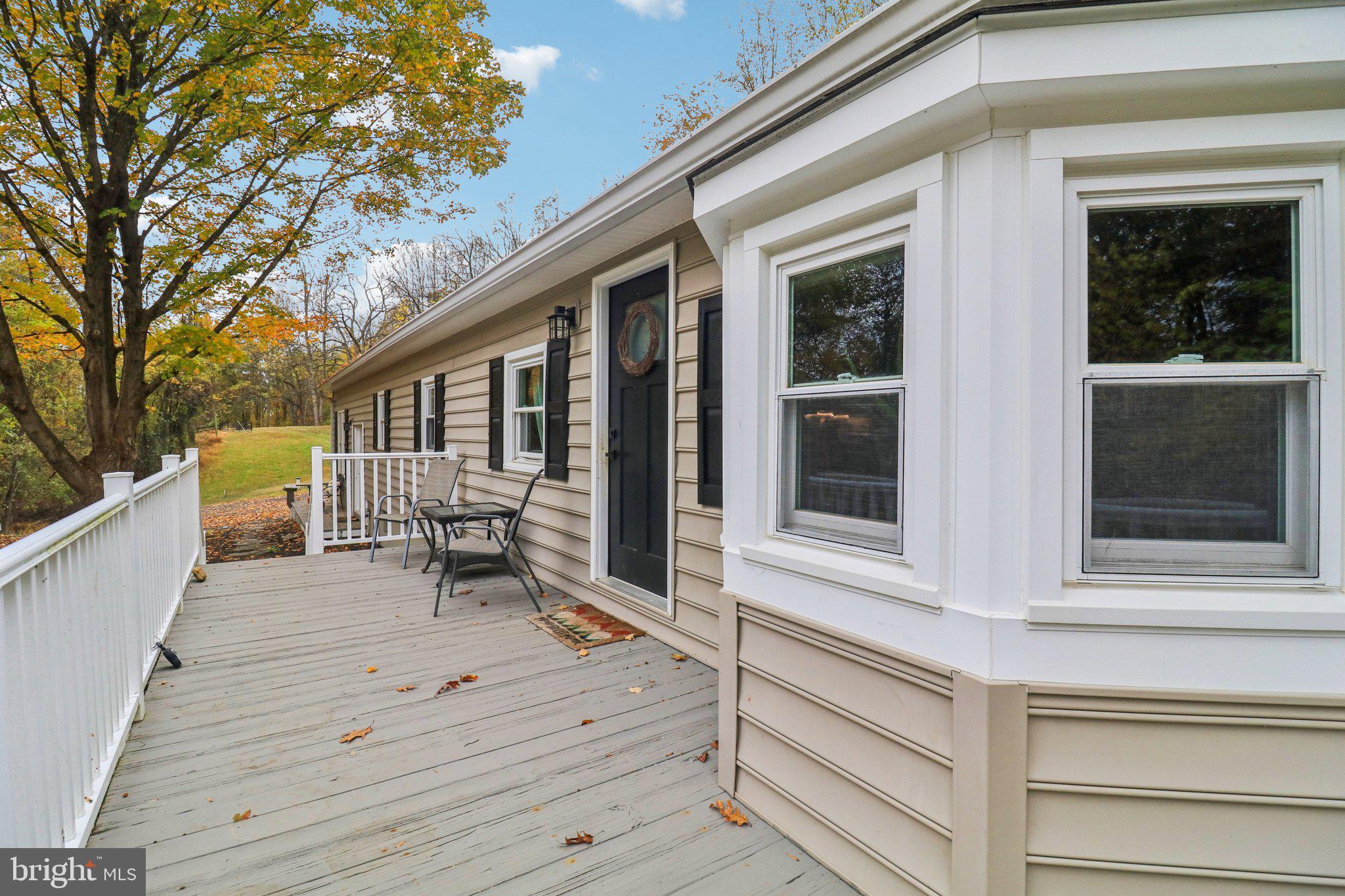 9830 Wineberry Road Marshall, VA 20115 - Photo 11 of 105 a view of house with deck and outdoor seating