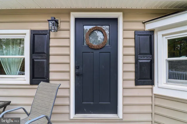 a kitchen with stainless steel appliances a white table and chairs in it