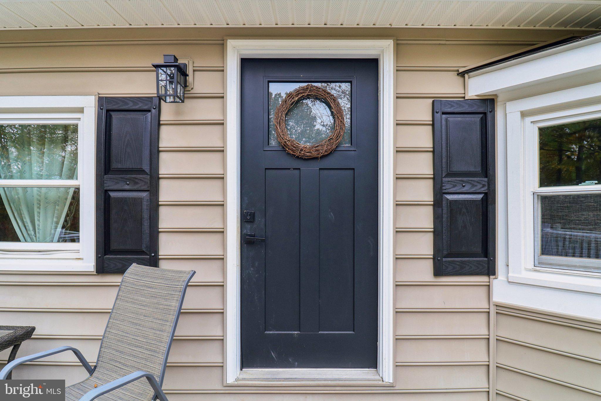 9830 Wineberry Road Marshall, VA 20115 - Photo 13 of 105 a front view of a house with entryway and wooden door