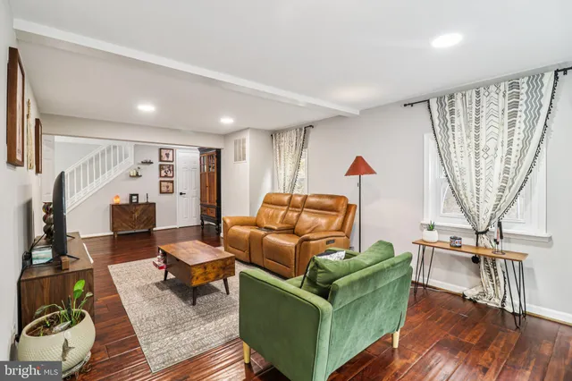 a kitchen with a sink and a stove top oven with wooden floor