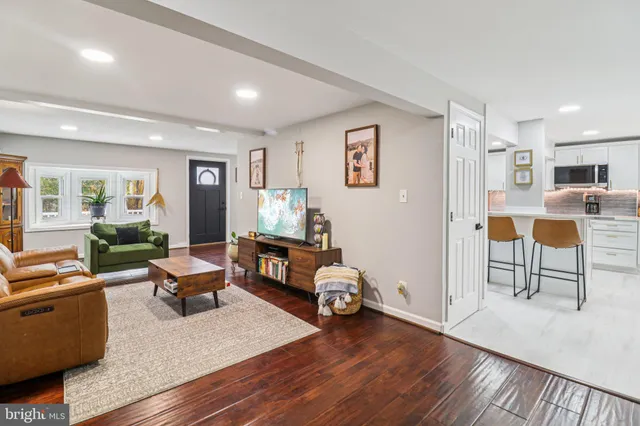 a bathroom with a granite countertop toilet sink and mirror