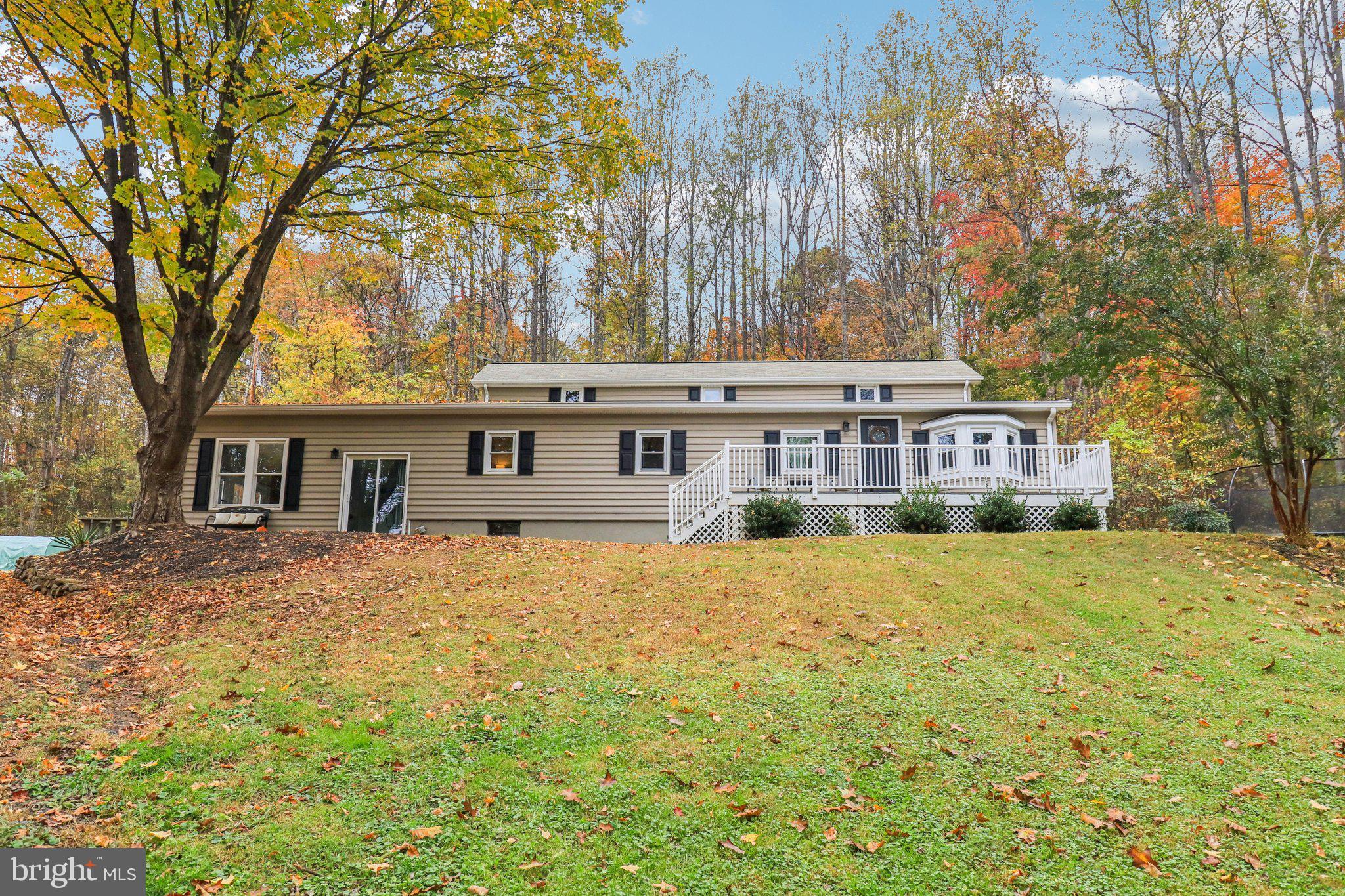 9830 Wineberry Road Marshall, VA 20115 - Photo 2 of 105 a front view of a house with a yard covered with snow and trees
