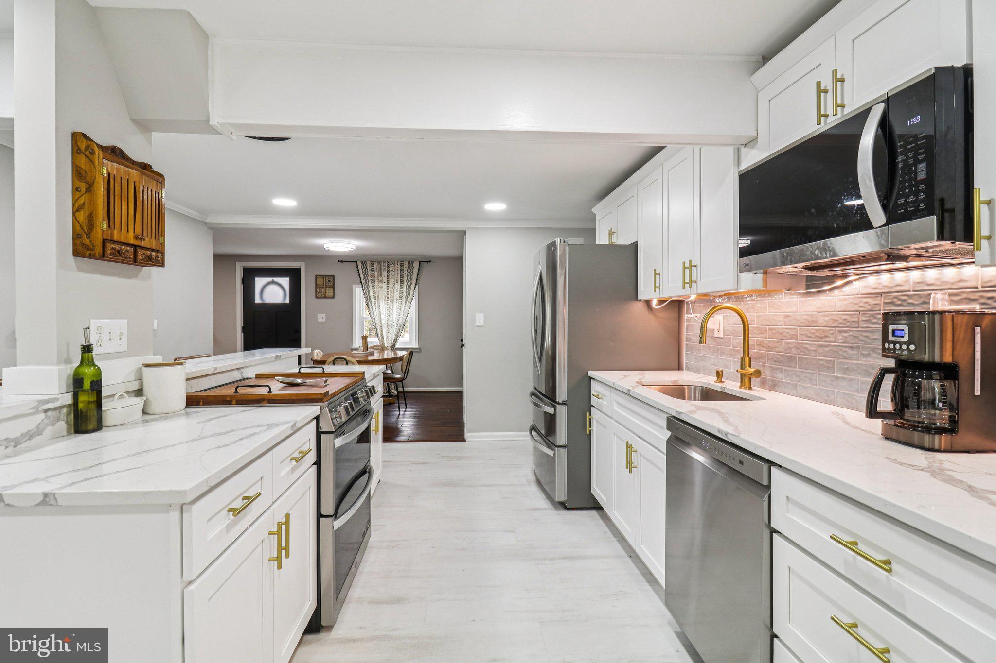 9830 Wineberry Road Marshall, VA 20115 - Photo 26 of 105 a kitchen with a sink and a stove top oven with wooden floor
