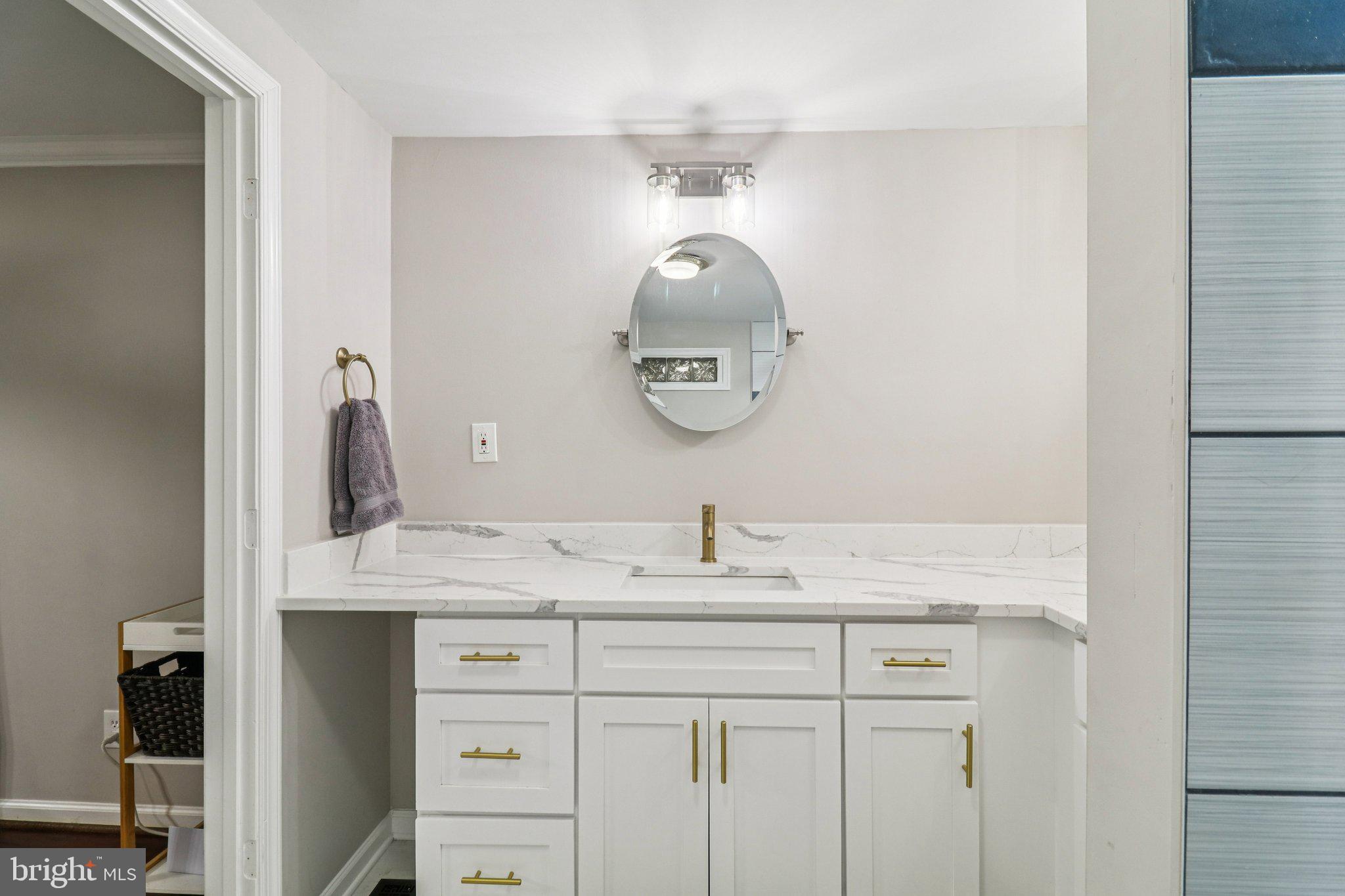 9830 Wineberry Road Marshall, VA 20115 - Photo 39 of 105 a bathroom with a granite countertop sink and a mirror