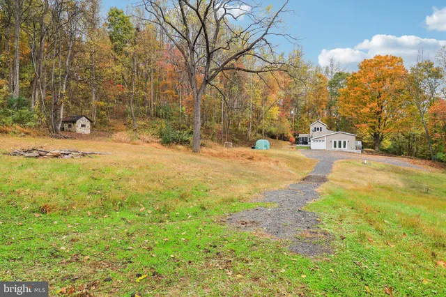 a view of house with deck and outdoor seating