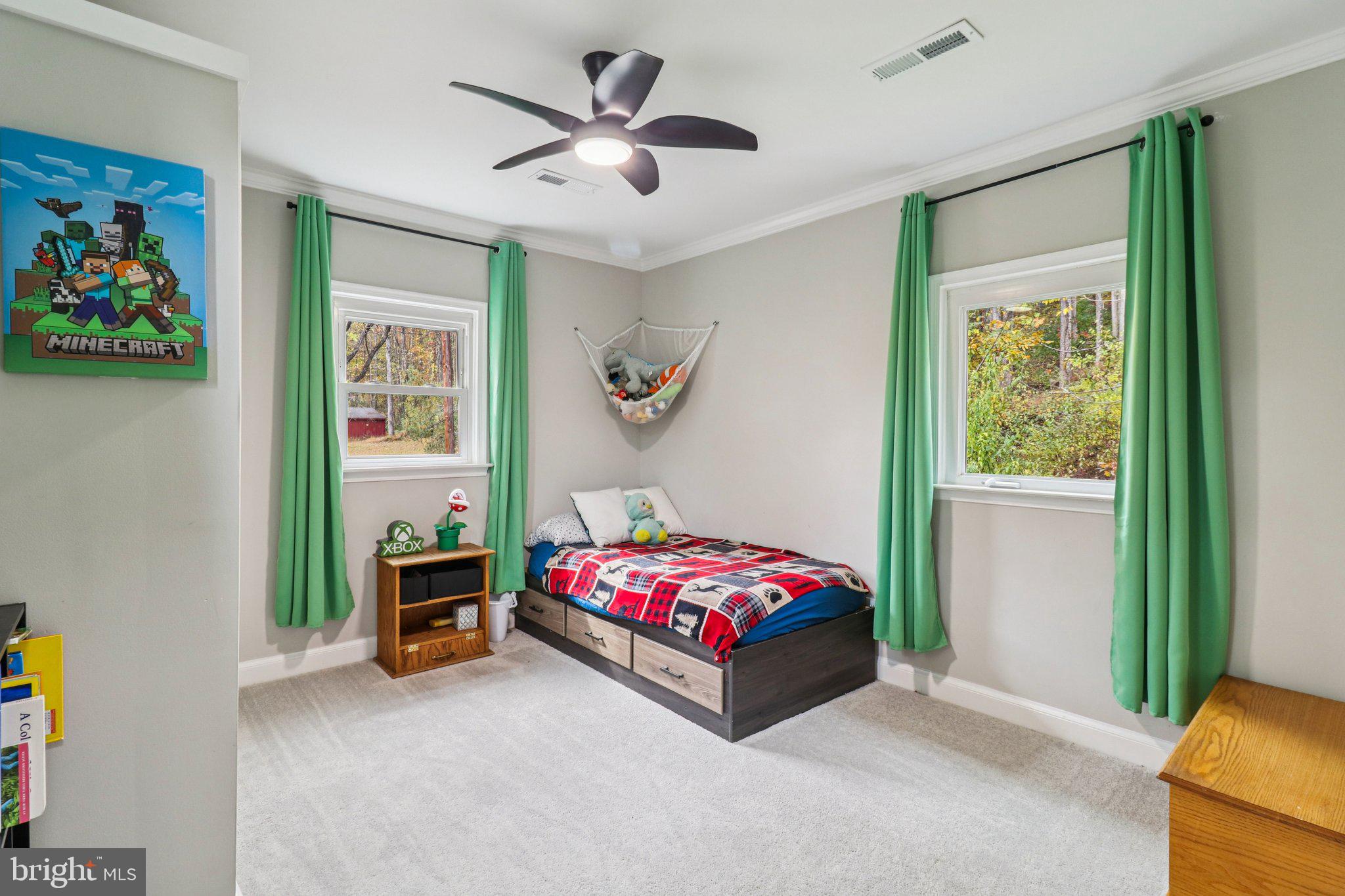 9830 Wineberry Road Marshall, VA 20115 - Photo 56 of 105 a bedroom with a bed and a chandelier