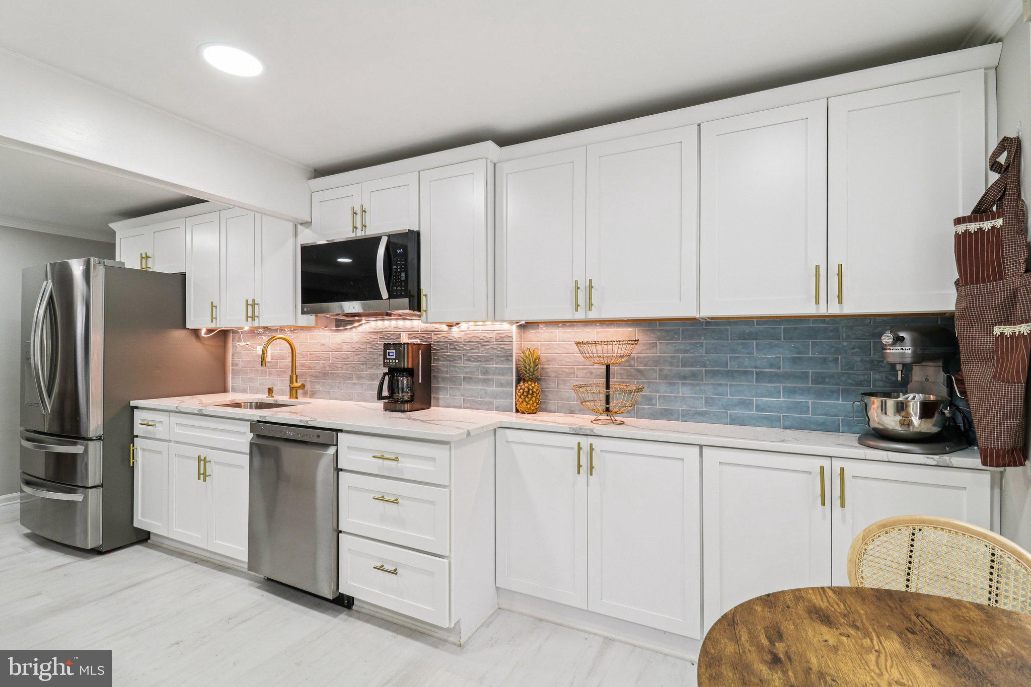 9830 Wineberry Road Marshall, VA 20115 - Photo 60 of 105 a kitchen with white cabinets stainless steel appliances and sink