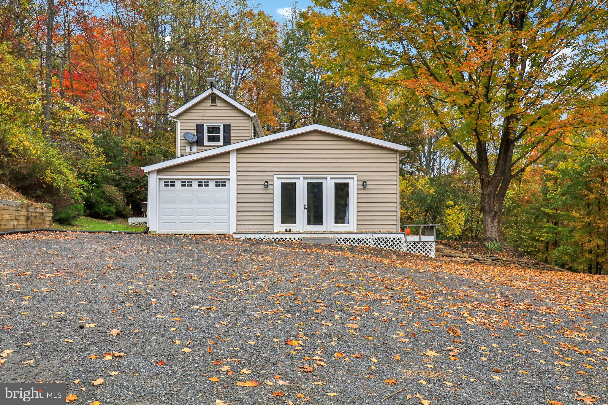 9830 Wineberry Road Marshall, VA 20115 - Photo 70 of 105 a front view of a house with a yard and garage