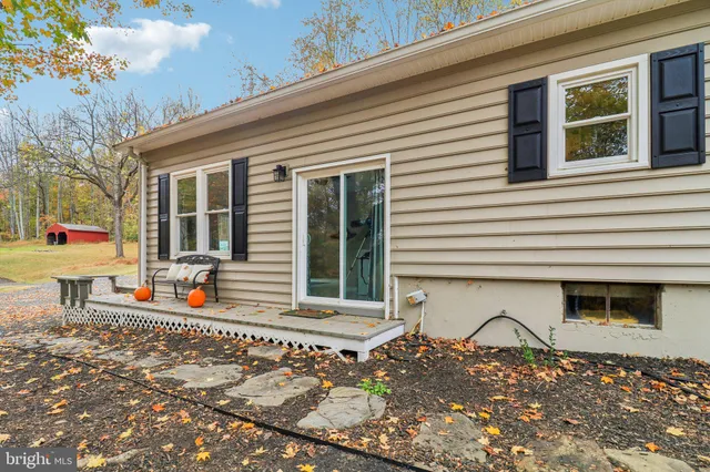a front view of a house with entryway and wooden door
