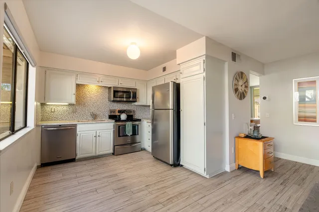 a bathroom with a granite countertop sink a mirror and vanity