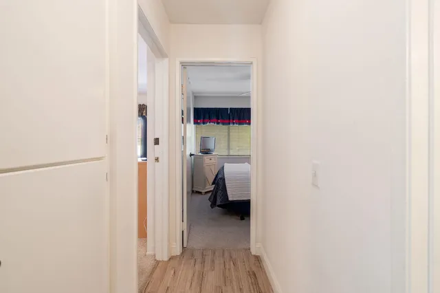 an aerial view of a city with lots of residential buildings ocean and mountain view in back