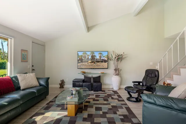 a view of a room with a table and chairs
