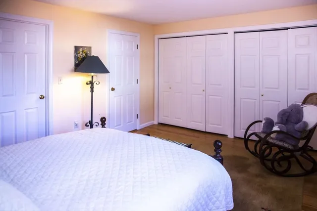 a bedroom with a bed and a chair