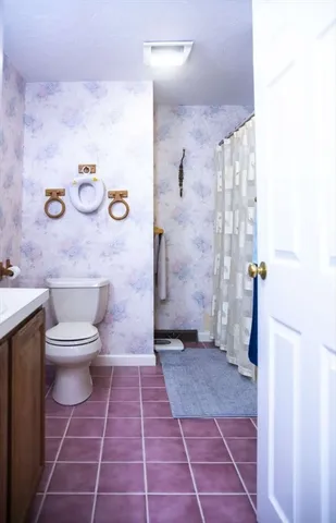 a bathroom with a toilet a sink and a shower