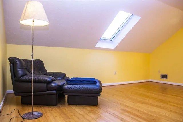 a living room with furniture and a lamp