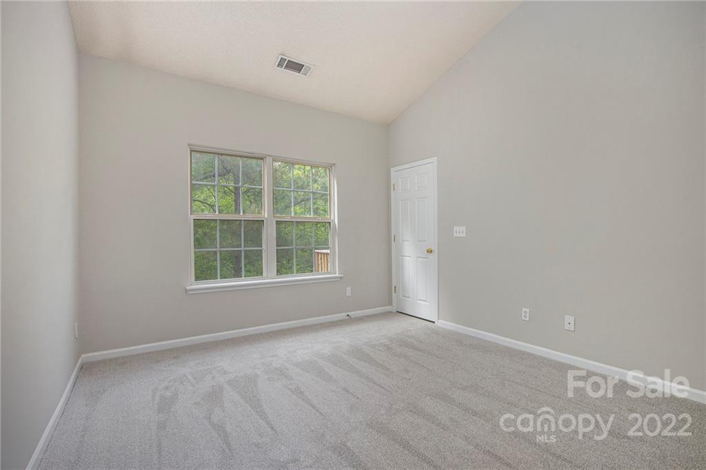 16852 Timber Crossing Road Charlotte, NC 28213 - Photo 11 of 31 an empty room with wooden floor and windows