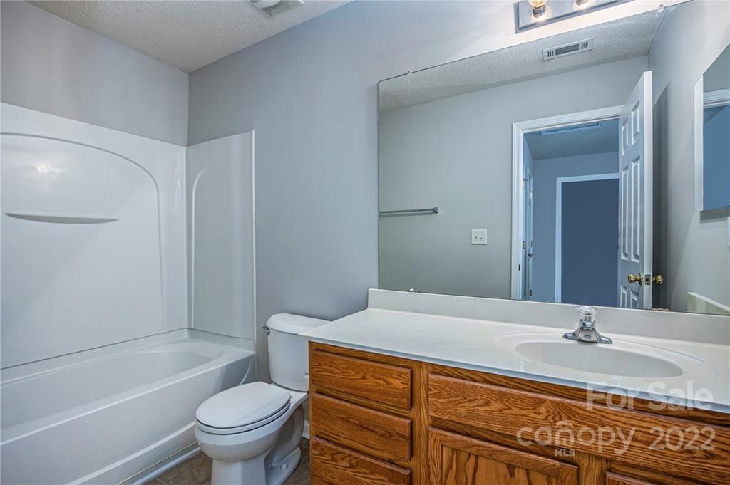 16852 Timber Crossing Road Charlotte, NC 28213 - Photo 18 of 31 a bathroom with a granite countertop sink toilet and shower