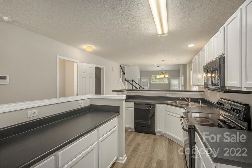 16852 Timber Crossing Road Charlotte, NC 28213 - Photo 2 of 31 a kitchen with stainless steel appliances granite countertop a sink stove and cabinets