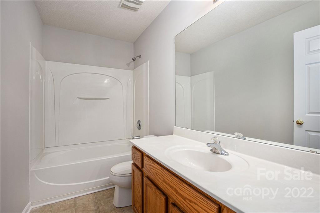 16852 Timber Crossing Road Charlotte, NC 28213 - Photo 25 of 31 a bathroom with a granite countertop sink toilet and shower