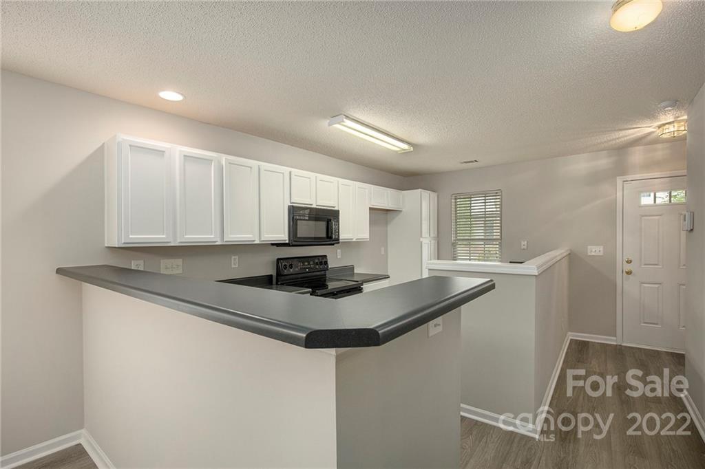 16852 Timber Crossing Road Charlotte, NC 28213 - Photo 5 of 31 a kitchen with stainless steel appliances granite countertop a sink and a stove