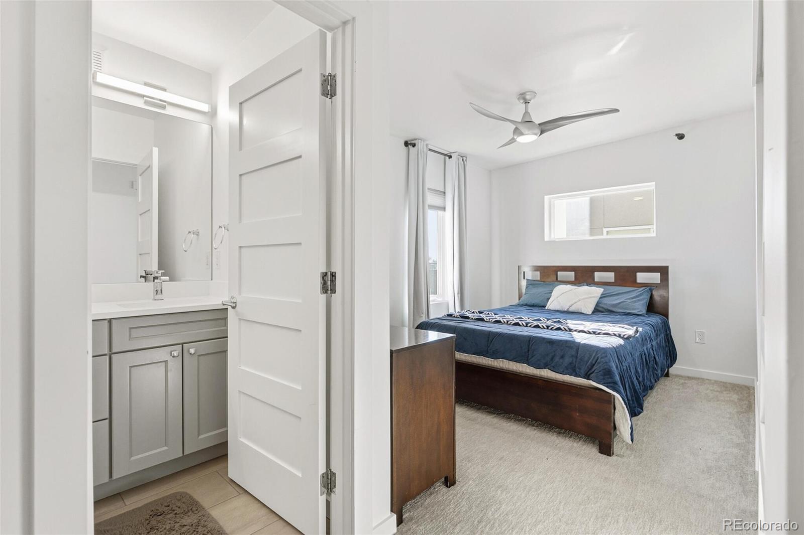 3850 West 13th Avenue Denver, CO 80204 - Photo 15 of 32 a bedroom with a bed and ceiling fan