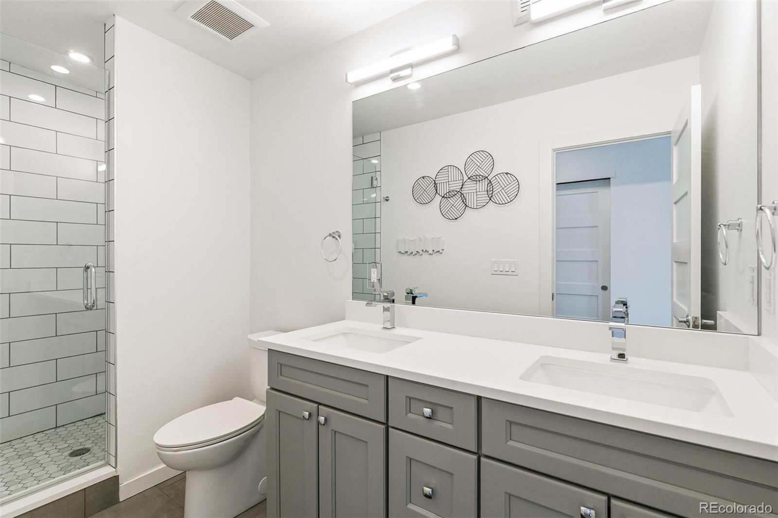 3850 West 13th Avenue Denver, CO 80204 - Photo 16 of 32 a bathroom with a sink a toilet and a mirror