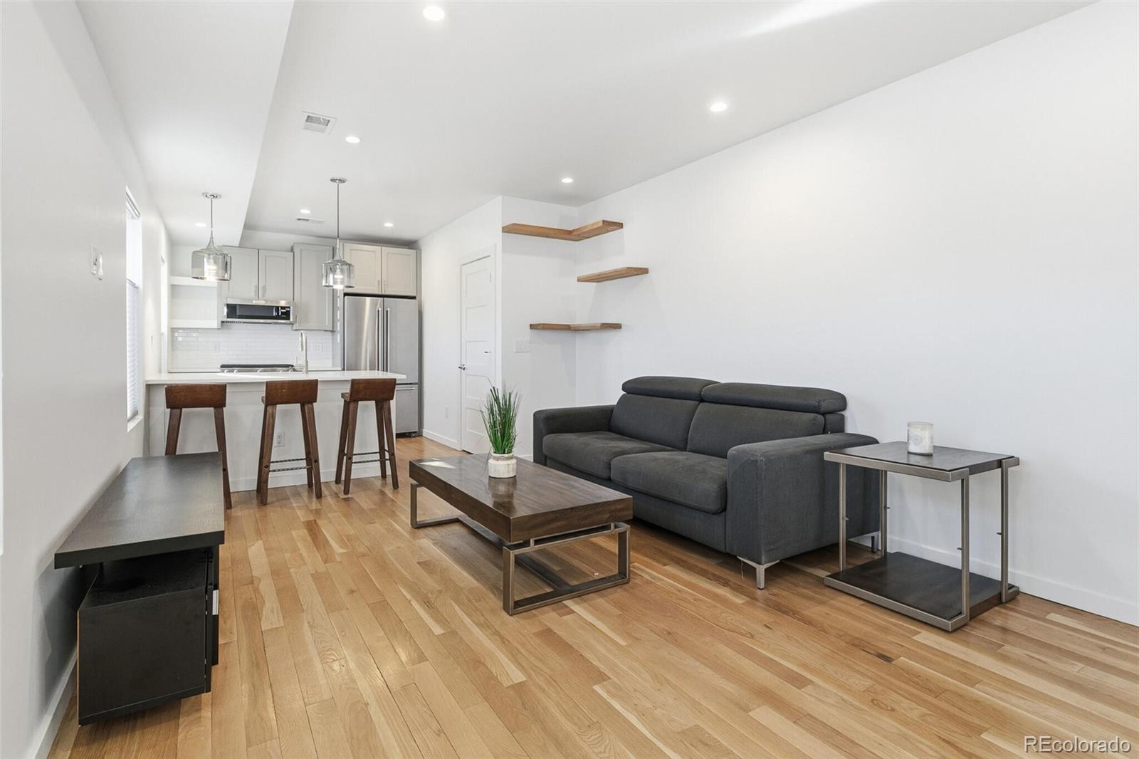 3850 West 13th Avenue Denver, CO 80204 - Photo 2 of 32 a living room with furniture and a table