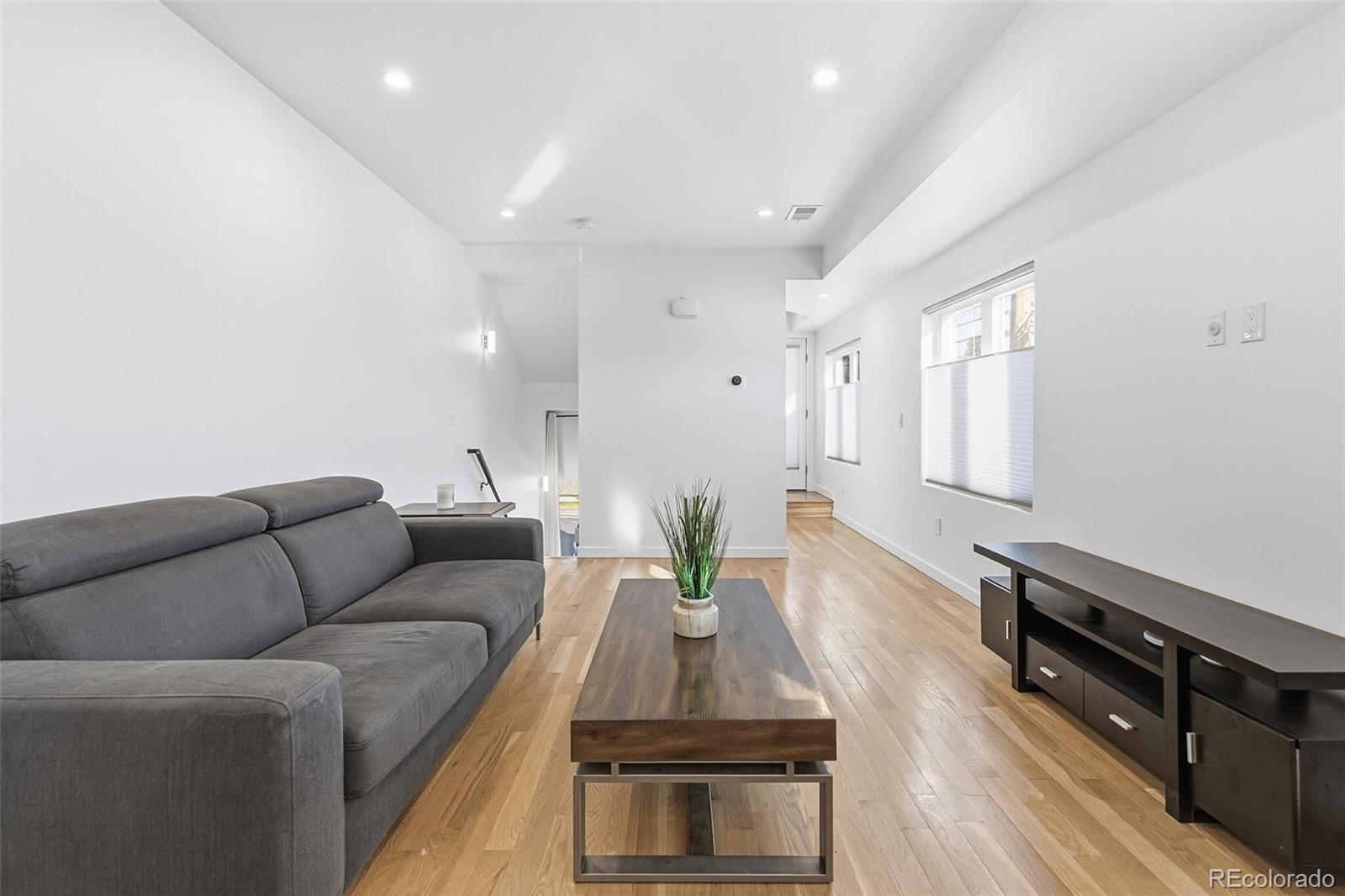 3850 West 13th Avenue Denver, CO 80204 - Photo 4 of 32 a living room with furniture and wooden floor