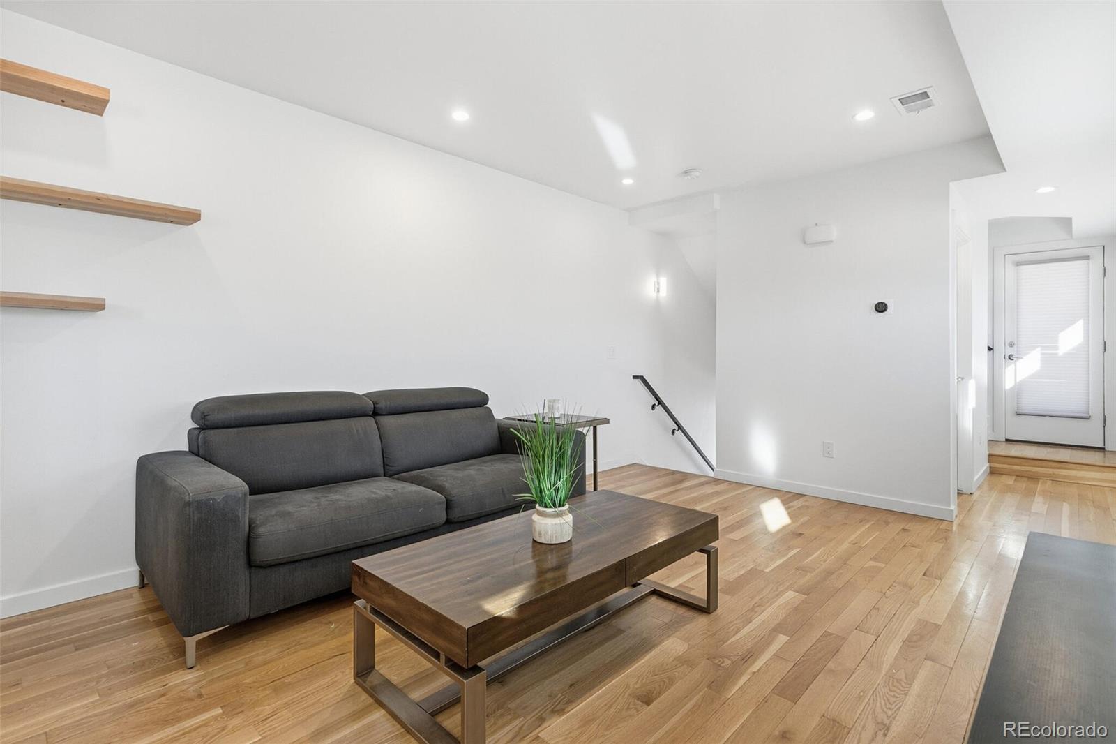 3850 West 13th Avenue Denver, CO 80204 - Photo 5 of 32 a living room with furniture and a wooden floor