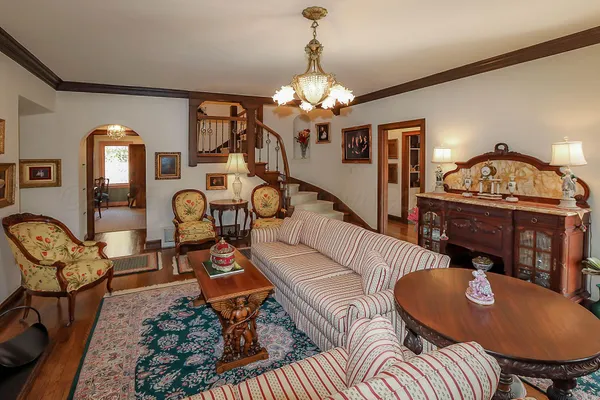 a view of a dining room with furniture a chandelier and window