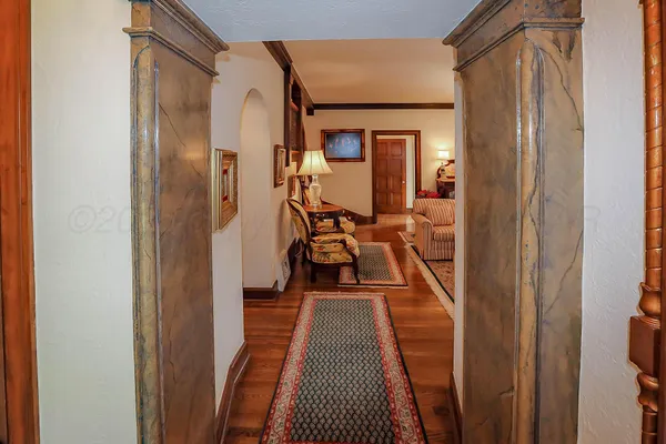 a living room with furniture a chandelier and a fireplace