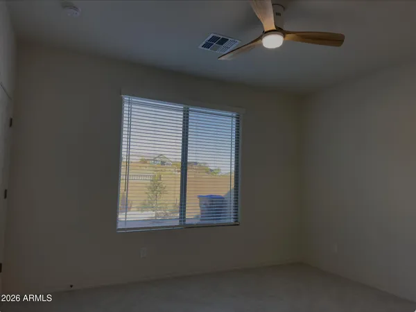 a view of a livingroom with a furniture and chandelier fan