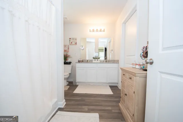 a bathroom with a sink a mirror and a shower