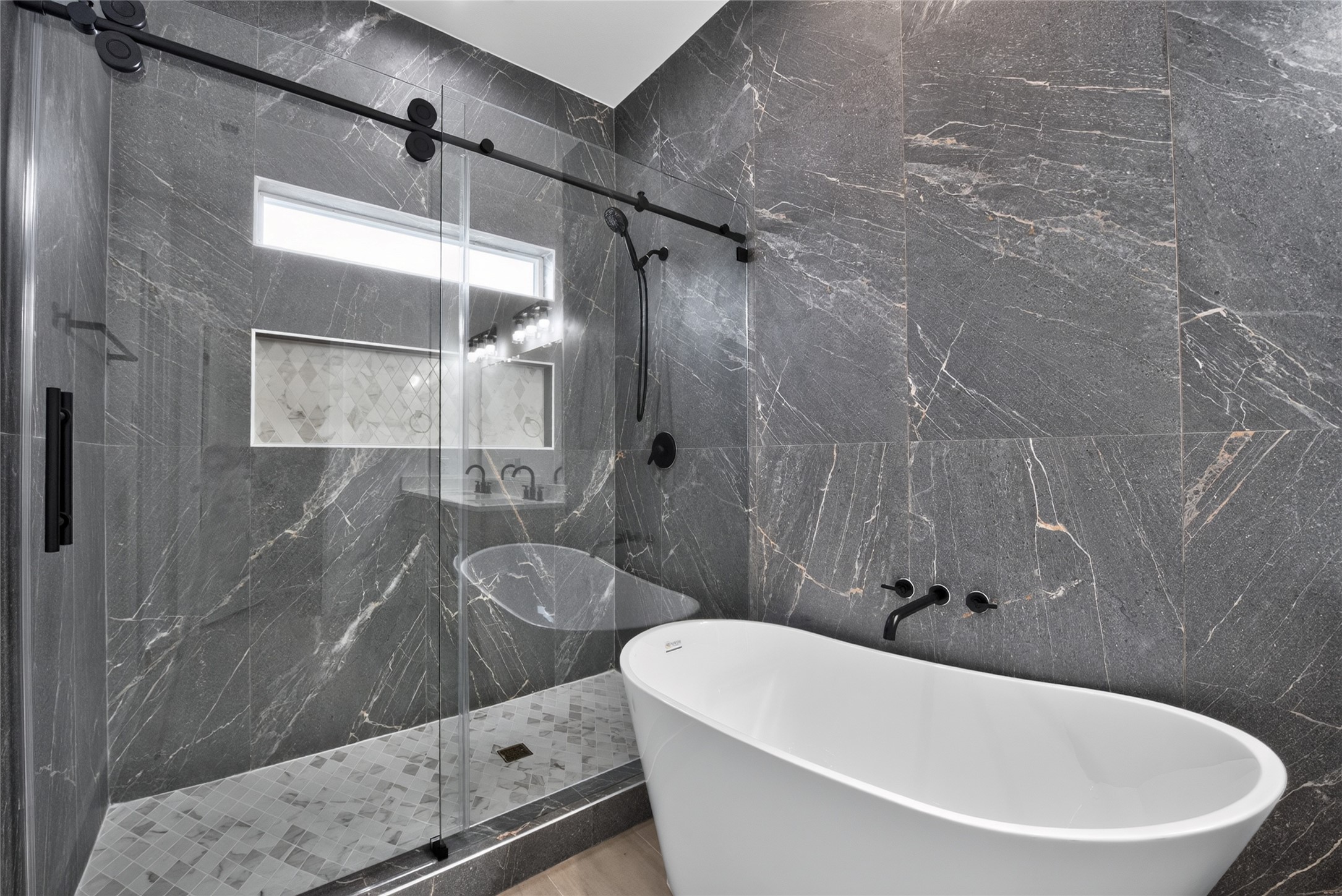 3537 Amos Street Houston, TX 77021 - Photo 26 of 32 Oversized and beautifully finished, the shower features sliding glass doors and floor-to-ceiling tile for a sleek, sophisticated look.