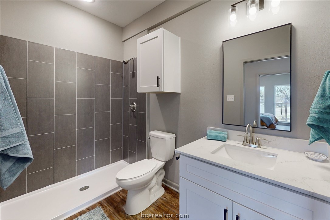 101 West 33rd Street, Unit 102 Bryan, TX 77803 - Photo 11 of 11 a bathroom with a sink a toilet and shower