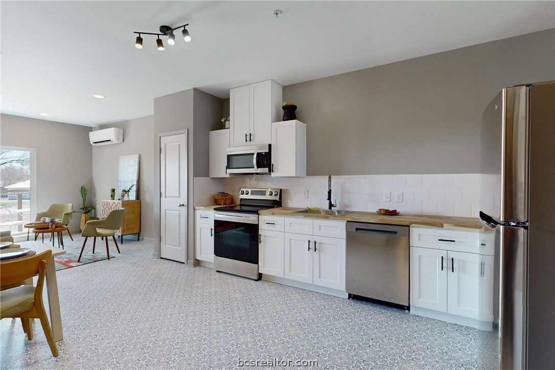 101 West 33rd Street, Unit 102 Bryan, TX 77803 - Photo 4 of 11 a kitchen with cabinets and stainless steel appliances