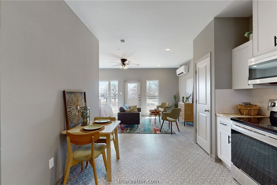 101 West 33rd Street, Unit 102 Bryan, TX 77803 - Photo 5 of 11 a living room with furniture a dining table and chairs in it