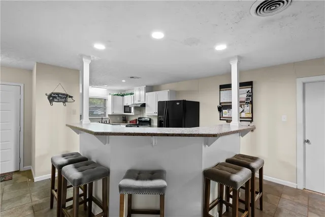 a kitchen with a table and chairs in it