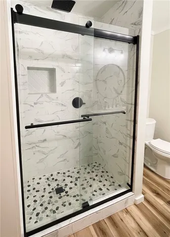 a bathroom with a sink toilet and shower