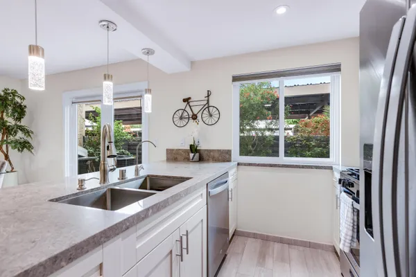 a kitchen with a sink and a large window