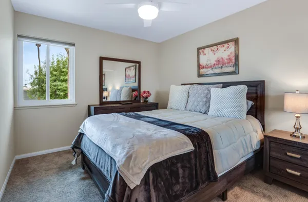 a bedroom with bed and a window